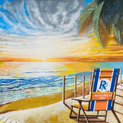 Colorful beach mural: sunny seascape, palm-fringed hut, a wooden pier, seagulls, and a striped beach chair facing the ocean. It ends with a quirky wink.