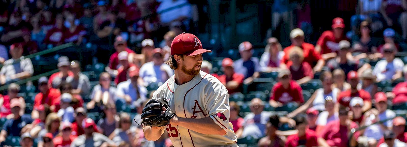 A pitcher from the San Francisco Giants winds up on the mound during a game, with the umpire and players in the infield ready for action.